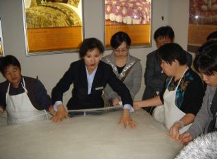 At a Silk Museum - stretching out the silk